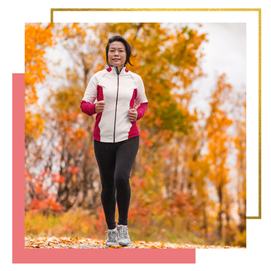 Image shows a middle-aged Asian woman out for a run on an autumn day